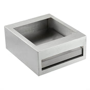 A square, half size stainless steel container with thick walls, angled inner sides, and an open top. It features a narrow horizontal slot near the bottom on one side. The brushed finish gives this TableCraft piece a modern, industrial look.