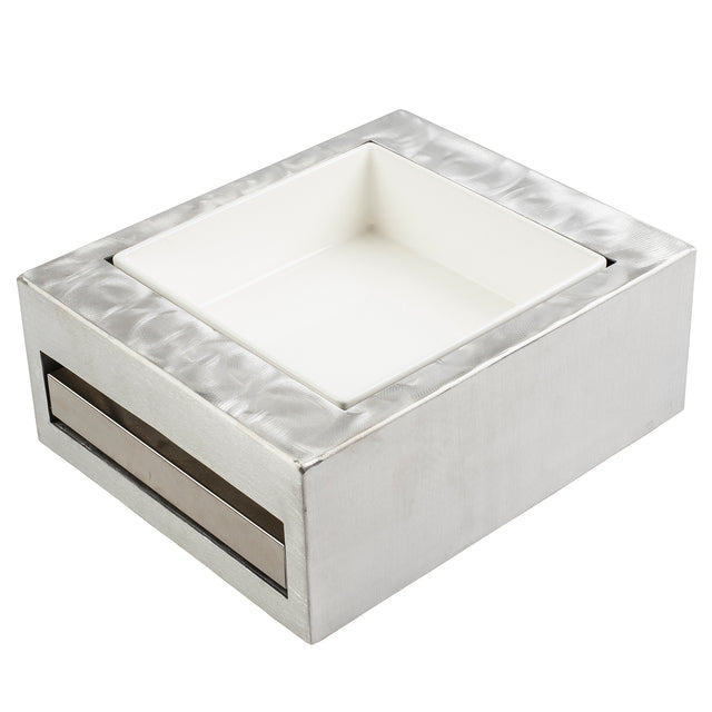 A modern, minimalist TableCraft square stainless steel container with a brushed, textured surface features a half size recessed, removable white ceramic dish in the center and a slot on one side—ideal as a sleek cooling station.