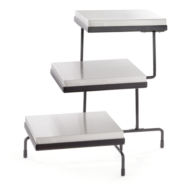 A 3-tiered metal display stand with rectangular, silver-colored cooling plates for shelves and black metal legs, each tier offset at different heights and positions, designed for showcasing items in a stepped arrangement.