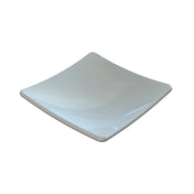 A square, shallow white ceramic plate with slightly upturned edges and a smooth, glossy surface, reflecting light in some areas. This Sierra Collection Spoon Rest is also dishwasher safe for easy cleaning.