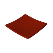 A shiny, square, deep red plate with slightly curved edges is centered on a plain white background. Crafted from cast aluminum, its smooth and reflective surface enhances the modern, minimalistic design.