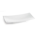 A plain, white, rectangular ceramic plate with slightly curved edges is shown against a white background. Its minimalist, modern design complements serveware like the Sierra Collection Bowl or a cold holding bowl for a cohesive table setting.