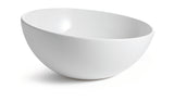 A plain, white, empty cold holding bowl is positioned at an angle on a white background. The bowl has smooth, clean lines and a glossy finish, with shadows underneath emphasizing its round shape.