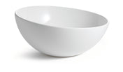 A plain, white Sierra Collection Bowl with smooth, curved sides is shown on a white background. Positioned at an angle, this cold holding bowl appears glossy and clean, with a subtle shadow beneath it.