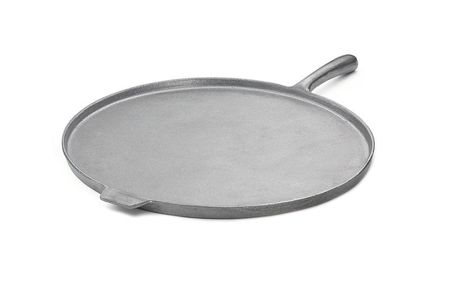 A flat, round, cast iron griddle with a slightly raised edge, a short side handle, and a smaller helper tab on the opposite side—ideal as a pizza pan—shown on a white background.