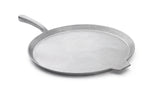 A round, flat, silver-colored cast aluminum pizza pan with a short, angled handle on one side and a small lip on the opposite edge, shown on a white background. The pan features a smooth surface and is dishwasher safe for easy cleanup.