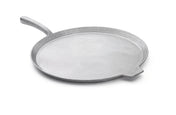 A round, flat, silver-colored cast aluminum pizza pan with a short, angled handle on one side and a small lip on the opposite edge, shown on a white background. The pan features a smooth surface and is dishwasher safe for easy cleanup.