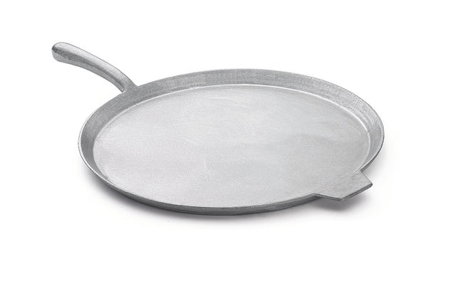 A round, flat, silver-colored cast aluminum pizza pan with a short, angled handle on one side and a small lip on the opposite edge, shown on a white background. The pan features a smooth surface and is dishwasher safe for easy cleanup.