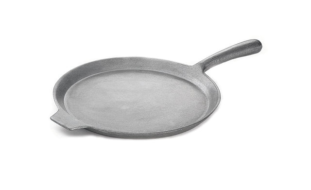 A round, flat cast aluminum skillet with a wide, slightly raised rim, a small pouring spout on one side, and a long, sturdy handle. The gray pizza pan is uncoated and shown on a plain white background.