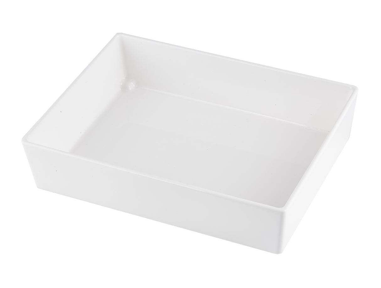 A rectangular, shallow, white ceramic Simple Solutions Bowl with smooth, glossy surfaces and slightly rounded edges, photographed on a white background and angled to show its depth and clean, minimalist design.