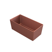 A rectangular, copper-colored Simple Solutions Bowl with straight sides and an open top is shown on a white background. Crafted from Duracoat coated cast aluminum, the bowl’s sharp edges and clean lines highlight its minimalist design.