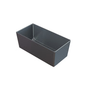 A rectangular, dark gray cast aluminum bowl with straight sides and sharp edges, open at the top, is shown against a plain white background. The Simple Solutions Bowl appears empty and clean, with a slight reflection on its surface.