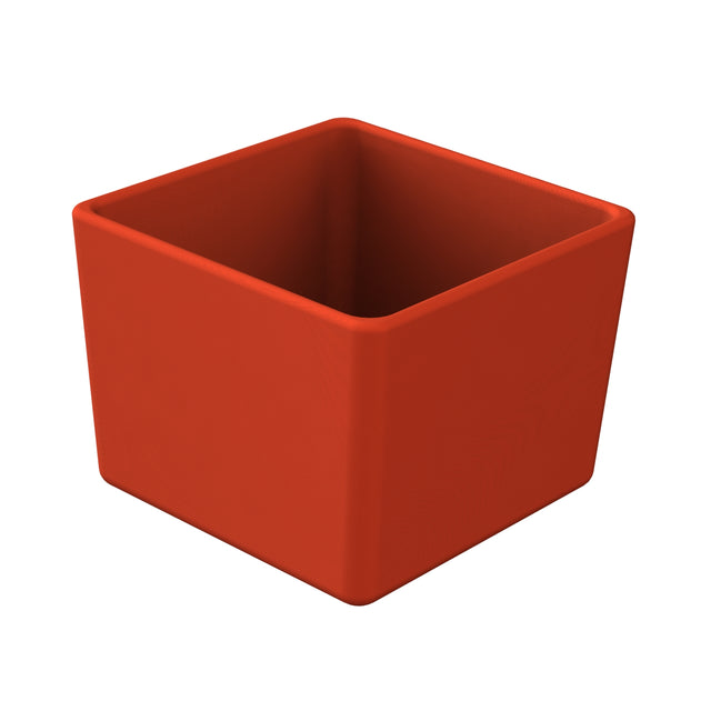 A simple, empty, red, square-shaped cast aluminum bowl with straight sides and slightly rounded edges; the container is positioned on a white background, its open top facing upward to reveal its hollow interior.