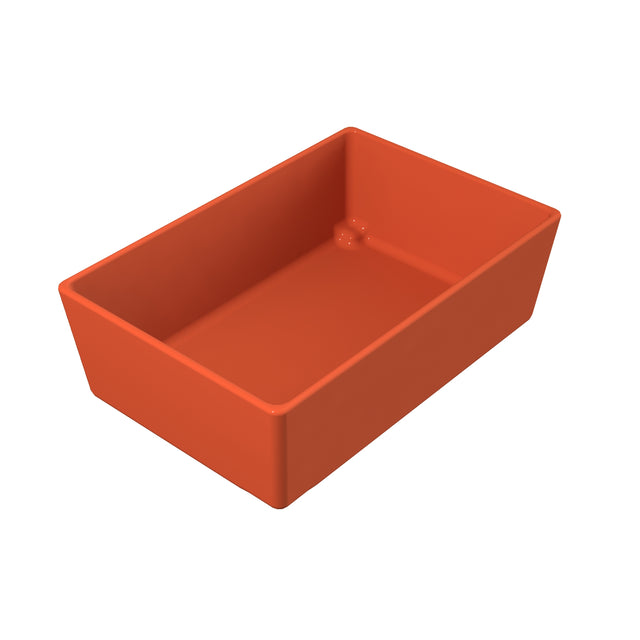 A rectangular, deep, sunset orange bowl with smooth sides and slightly rounded edges, shown from an angled top-down view on a white background. The interior bottom surface is flat with a small raised circle in one corner.