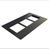 A black rectangular plastic switch plate cover with three cutouts, ideal for triple switches or outlets, is shown lying flat on a white background and viewed from an angle—perfect for use in NSF-7 certified environments.