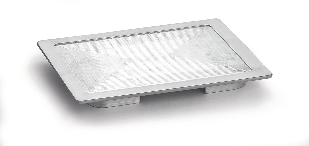 A rectangular, modern silver LED recessed step light with a textured glass lens and an aluminum metal frame, photographed on a white background, viewed at a slight angle from above. The design resembles a half size Hot Well Cover in its sleek profile.