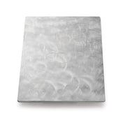 A rectangular sheet of brushed stainless steel with a matte finish. Swirling, circular patterns are etched into the metal, creating a textured appearance. The plain white background highlights its reflective quality—plus, it’s dishwasher safe.