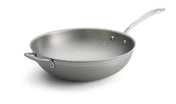 A tri-ply wok with a shiny stainless steel finish, featuring a wide, rounded base and tall sides. It includes a long handle and a riveted helper handle for stability—plus, this dishwasher safe wok is set against a white background.