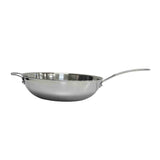 A shiny tri-ply stainless steel sauté pan with a rounded base, a long handle on one side, and a short helper handle on the opposite side, is shown against a plain white background. Dishwasher safe for convenient cleaning.