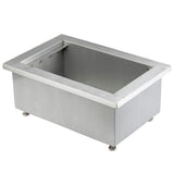 A rectangular stainless steel TableCraft CW8002BRA Single Ice Well or drop-in pan with a wide rim, viewed at an angle. The deep interior is empty, the brushed metal finish exterior features four small adjustable feet at the base corners.