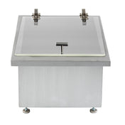 Rectangular stainless steel box with a flat, clear acrylic lid featuring a metal handle at the center front. Two metal hinges are visible at the top, and the box stands on four small adjustable feet, one at each corner.