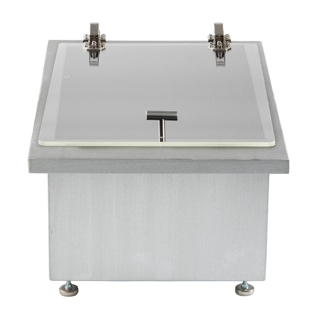 Rectangular stainless steel box with a flat, clear acrylic lid featuring a metal handle at the center front. Two metal hinges are visible at the top, and the box stands on four small adjustable feet, one at each corner.