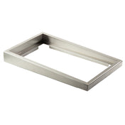A rectangular, metallic, stainless steel frame with a wide, flat border rests on a white background. This modern riser features clean, straight edges and a shiny finish, combining sleek style with durable, dishwasher-safe convenience.