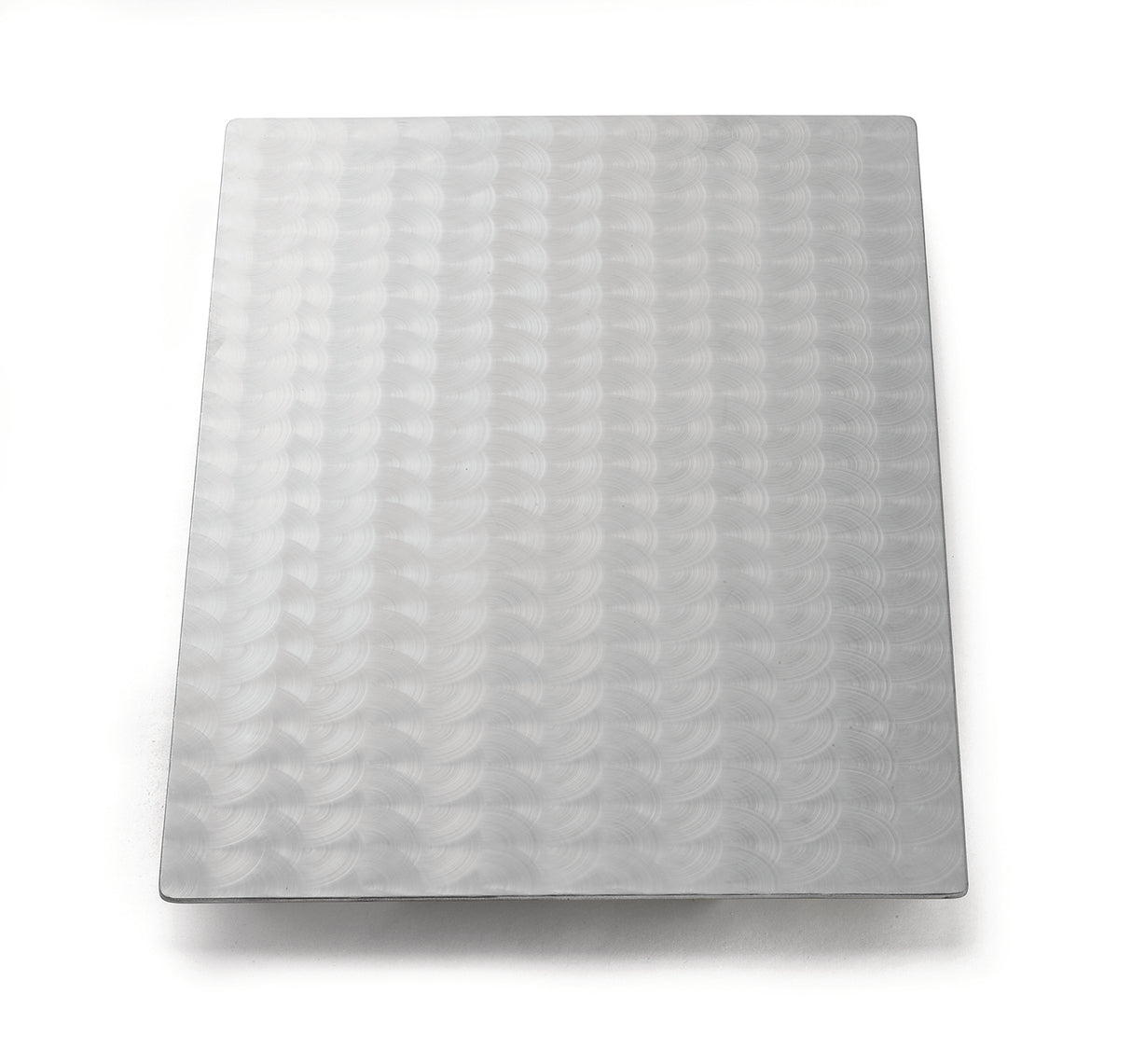 A rectangular sheet of Duracoat coated cast aluminum with a repeating circular swirl pattern covers the surface. The light gray, reflective metal is dishwasher safe and placed on a plain white background with soft shadows around the edges.