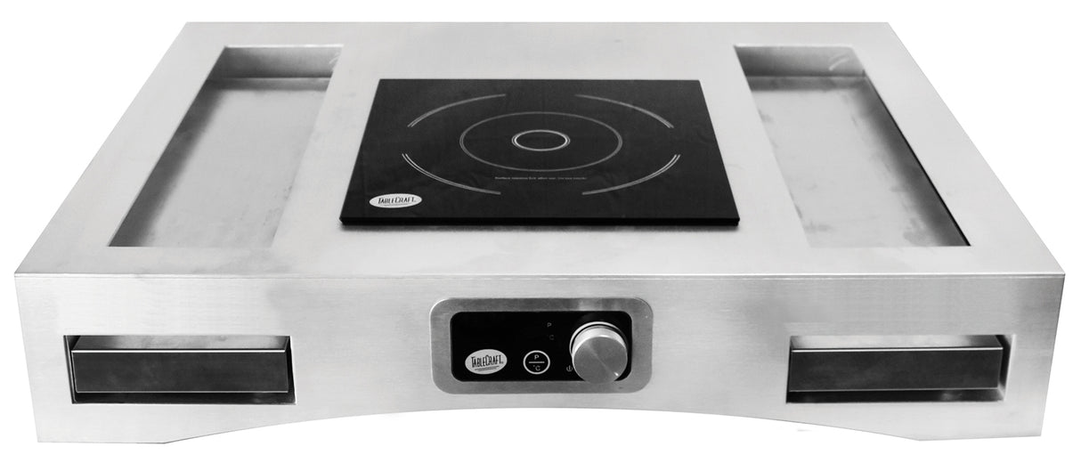A sleek, modern stainless steel Induction Countertop Station Kit features a black square electric induction cooktop at the center, a control knob and digital display on the front, and two open rectangular cooling plates on each side.