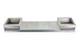 A rectangular metallic object with a wide central platform, resembling a TableCraft double burner. Two square compartments with front slots sit on either side. The symmetrical, industrial design features a smooth steel-like finish against a plain white background.