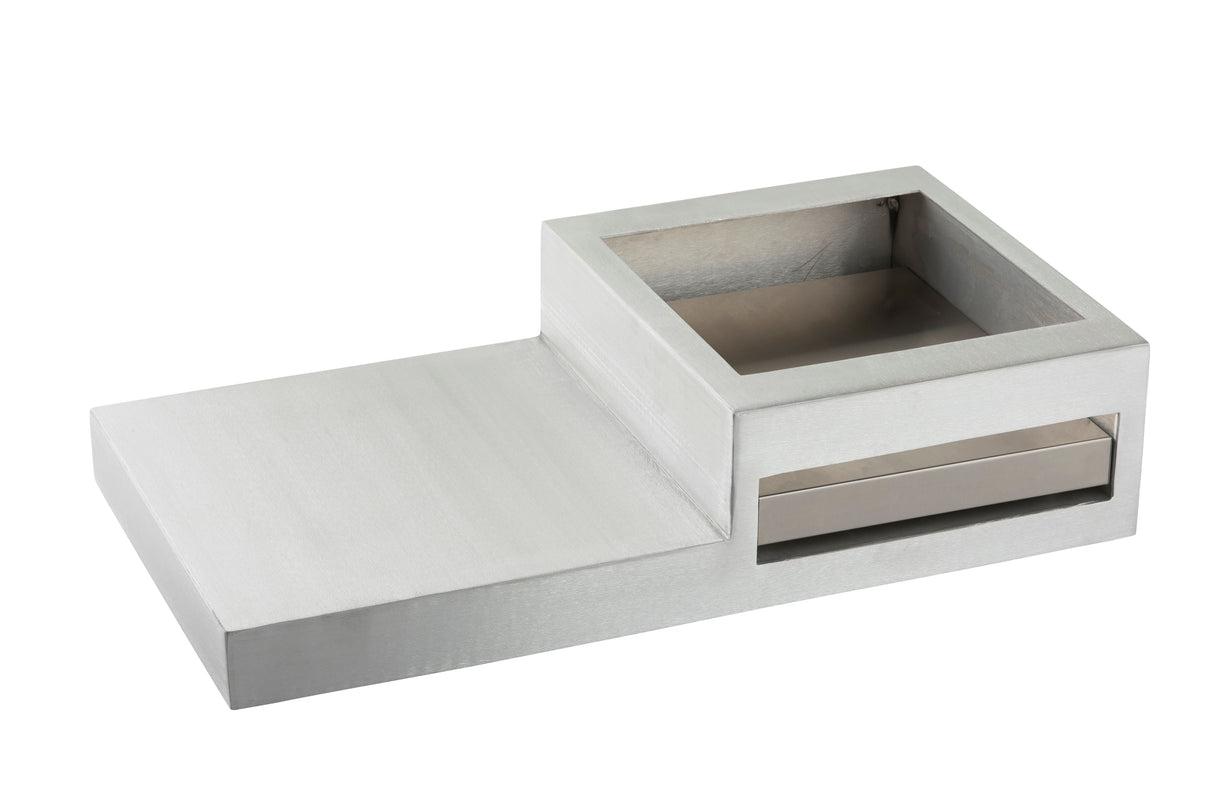 A modern, rectangular, metallic Action Station with a raised square compartment on one side and a flat surface on the other. The minimalist design includes an open-top compartment and a horizontal slot beneath it, ideal for a single burner setup.
