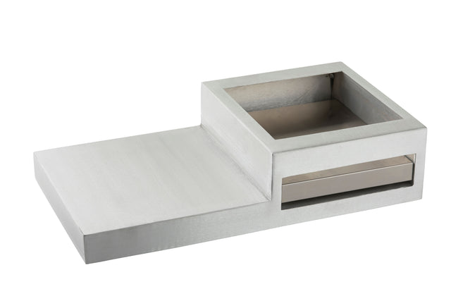 A modern, rectangular, metallic Action Station with a raised square compartment on one side and a flat surface on the other. The minimalist design includes an open-top compartment and a horizontal slot beneath it, ideal for a single burner setup.