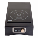 A black, rectangular Induction Station cooktop with a single burner features white concentric circles on its glass surface and a control panel below with a silver knob, digital display, and TableCraft Products branding on both the surface and panel.