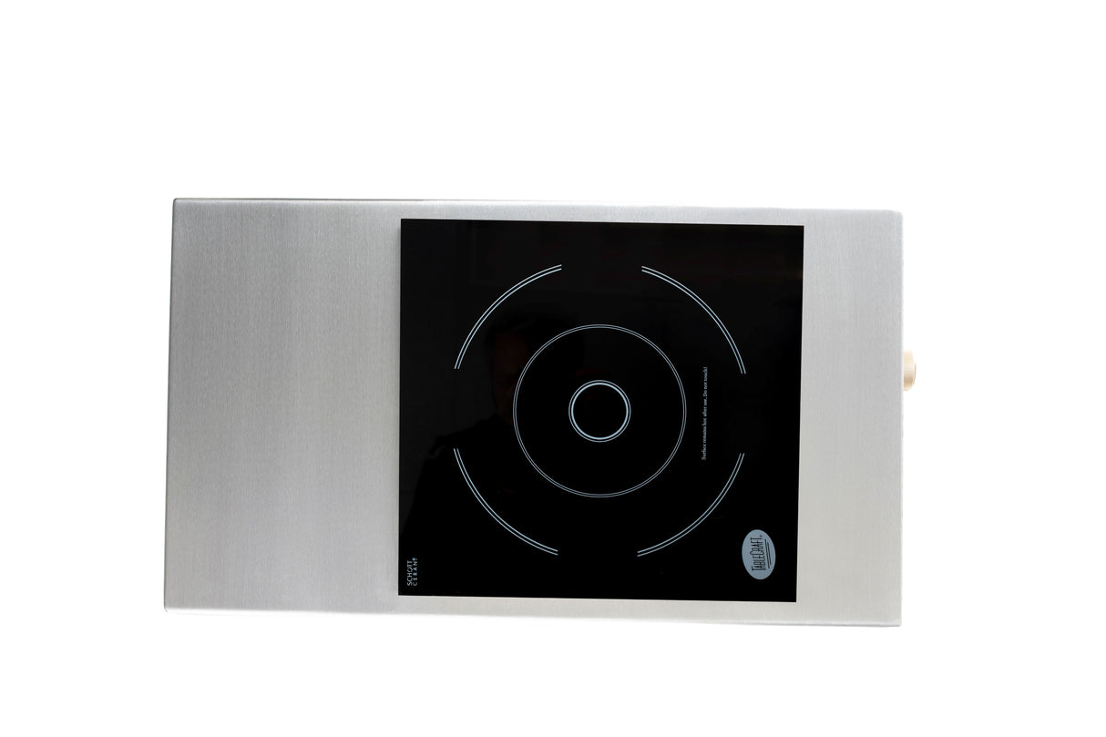 A rectangular TableCraft Products Induction Station with a stainless steel body and a single burner black glass cooking zone, featuring concentric white rings indicating the burner area, shown on a white background.