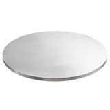 A round, flat, silver metal disc resembling a sleek TableCraft aluminum round table cover is displayed on a white background. The reflective tabletop cover has a smooth surface and thin edge with subtle light reflections.