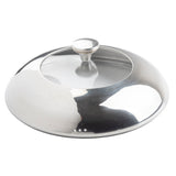 A shiny, round stainless steel pot lid with a central handle sits atop a die-cast aluminum casserole dish. Its highly reflective surface shows light and shadow, while three small steam holes near the rim complement its gently curved edges.