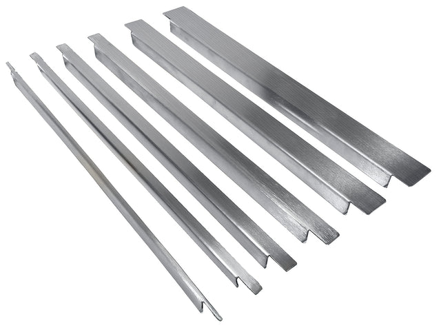 Six long, stainless steel bars of varying widths and lengths are arranged in a row on a white background. Each bar in this TableCraft spacer bar kit has a smooth, slightly reflective surface with distinct grooves or notches on the ends.