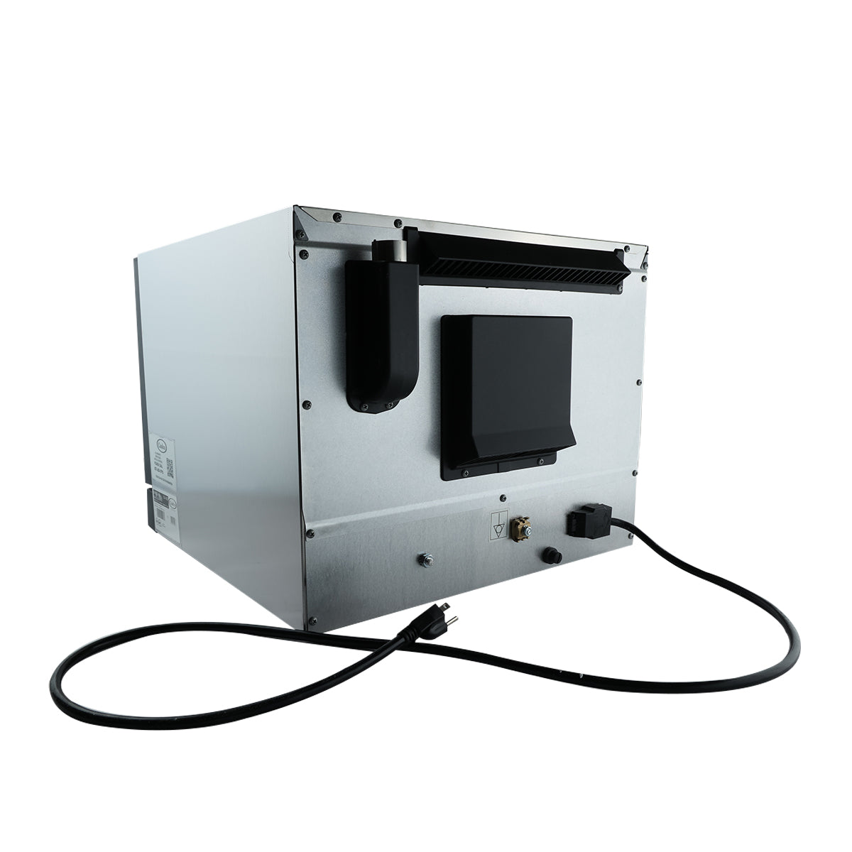 A stainless steel commercial ice maker machine, similar in size to a quarter size convection oven, is shown from the back. Visible are a black power cord, vent, water intake, and various panels. The machine sits on a white background.
