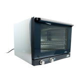 A countertop half size convection oven with a front glass door, two control knobs at the bottom, and wire shelves inside. The oven is plugged in, showcasing a modern design with black accents around the door and controls.