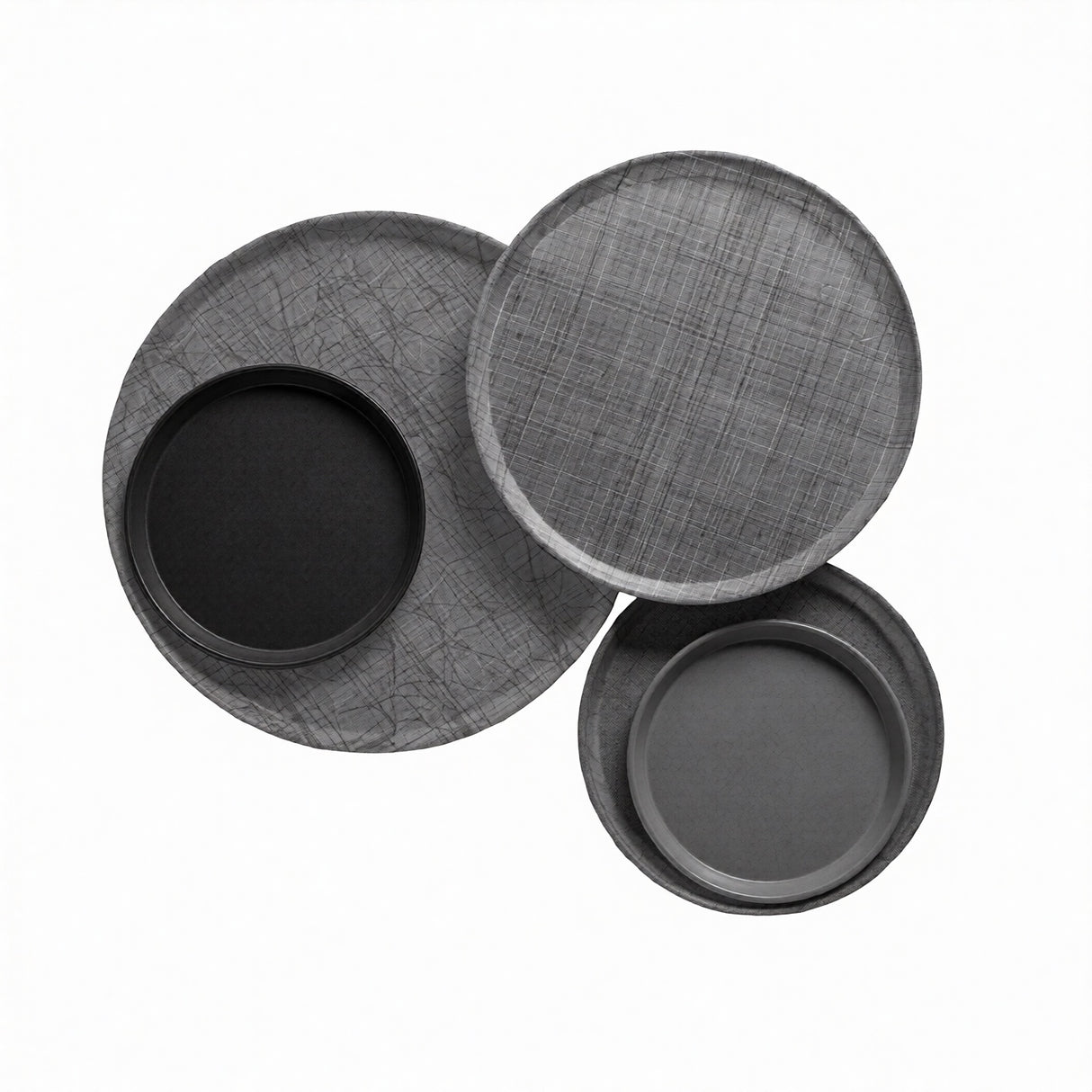 Three round trays are arranged overlapping on a white background. Two trays, crafted from fiberglass, have a subtle crisscross texture, while two smaller, smooth Serving Camtrays—dishwasher safe—are nested inside the larger trays.