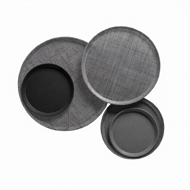 Three round trays are arranged overlapping on a white background. Two trays, crafted from fiberglass, have a subtle crisscross texture, while two smaller, smooth Serving Camtrays—dishwasher safe—are nested inside the larger trays.