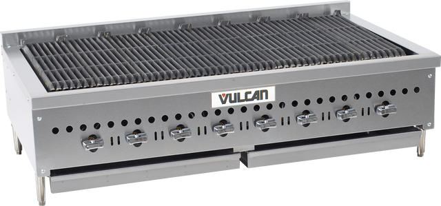 A large, stainless steel gas countertop charbroiler with six control knobs, a wide grilling surface with cast iron burners, and ventilation holes along the front. The “Vulcan” brand name is centered on the front panel. The unit stands on short legs.