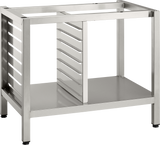 Stainless steel Deluxe Stand open-frame kitchen rack with a rectangular shape, featuring multiple horizontal slots on one side for tray or pan supports, a flat bottom shelf, and sturdy square legs with black feet. The top and front are open, showing the interior structure.