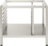 A stainless steel, open-frame Deluxe Stand with four legs, side rails on the left, and a solid lower shelf. Designed for 102 TCM units or pan supports, it features a sturdy, minimalist industrial look and a clean metallic finish.