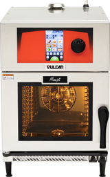 A commercial Vulcan Mini-jet combi oven with a digital touchscreen control panel and a large windowed door. The ventless oven’s interior is lit, showing metal racks and a fan. The stainless steel exterior features safety labels and a black handle.