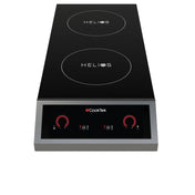 A sleek black CookTek Helios double hob induction cooktop with two circular burners on top and a control panel below, featuring red dials, icons, and a digital display set in a stainless steel frame for ultimate portable design.
