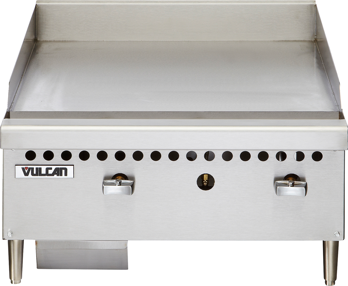 The Vulcan VCRG24-M is a stainless steel 24" countertop gas griddle with two control knobs, smooth flat-top surface, short metal legs, small ventilation holes above the knobs, and a grease tray underneath on the left side.