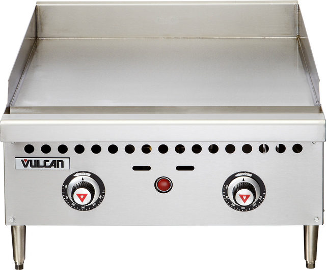 A stainless steel Vulcan VCRG24-T countertop gas griddle with two round control knobs, a red indicator light in the center, and a vented front panel. The 24 inch griddle features a flat cooking surface with raised side and back guards, plus four short legs.