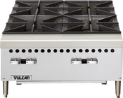 A commercial Vulcan stainless steel gas countertop hotplate with four heavy-duty cast iron burners, front-mounted control knobs, ventilation holes, and a Vulcan logo on the lower left corner. The appliance stands on four short legs.