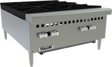 A commercial stainless steel gas hotplate with two large black cast iron burners on top, two silver control knobs below, ventilation holes along the front, and the Vulcan logo on the lower panel. The countertop hotplate stands on short legs.